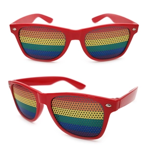 Detail of red party sunglasses featuring rainbow pinhole lenses and a classic frame