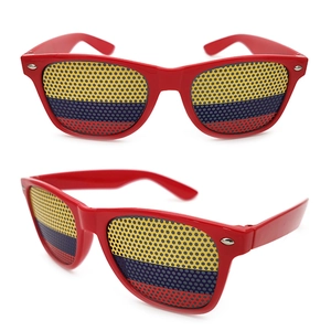 Close-up of red frame sunglasses with tri-color flag pattern and perforated lenses
