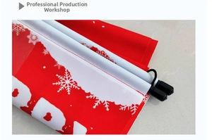 Close-up of red Christmas scroll banner with white snowflakes and hanging rope detail