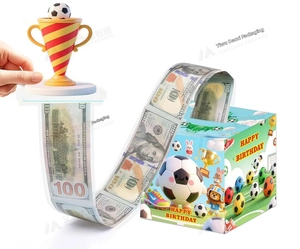 Detail of soccer theme money pull box set with trophy topper for birthday cake decoration