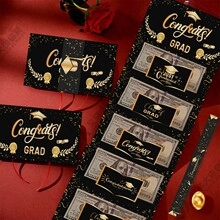 Macro shot of Graduation cash pull box with Congrats Grad gold foil lettering and red ribbon