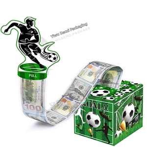 Detail of football themed money pull box with soccer player topper and prop cash notes