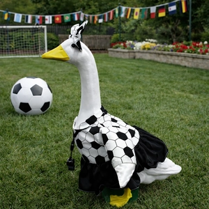 Soccer themed lawn goose statue wearing black and white football jersey and whistle