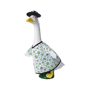 Detail view of white garden goose statue wearing green soccer print outfit and matching hat
