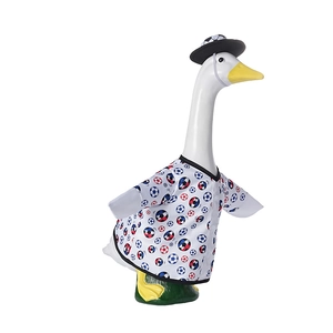 Detail view of 23-inch garden goose statue wearing soccer print outfit and black hat