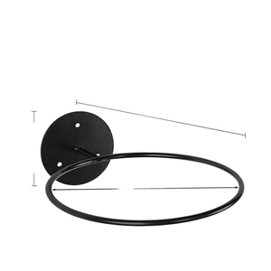Wall-mounted black iron ball storage rack with a circular metal frame for sports equipment