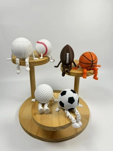 Detailed view of 6-piece articulated sports ball figurines on a wooden display stand