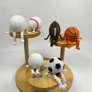 Creative 3D printed sports ball figurines with movable joints on a wooden display stand