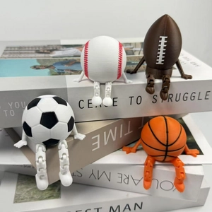 Creative 3D printed articulated sports ball figurines sitting on books set of four