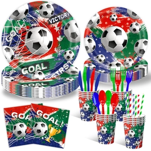 Dettaglio del set da festa a tema calcio con piatti di carta, bicchieri e trofei d'oro