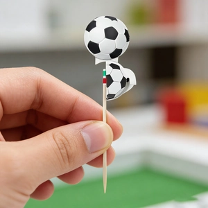 Close-up of a wooden football toothpick topper showing detail for party food decoration