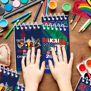Spiral notebook with 2026 soccer theme on a wooden desk with artistic stationery tools