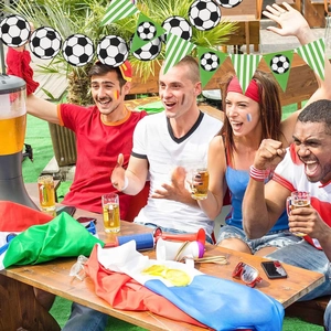Soccer theme birthday party banner with football cards and green white striped pennants
