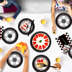Macro shot of racing tire theme party plates and checkered napkins for birthday events
