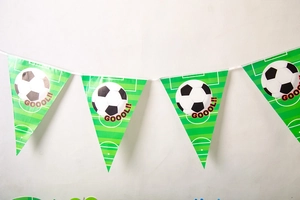 Close-up of green football party pennant banner with GOOOL text and soccer field design