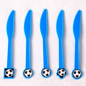 Blue plastic party knives with football patterns on white plush textured background