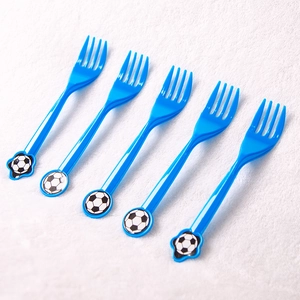 Close-up of blue plastic party forks featuring classic soccer ball patterns on handles