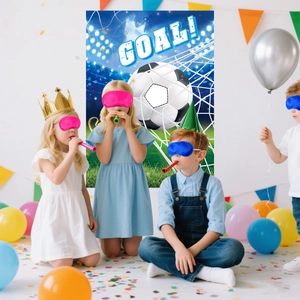 Kids playing interactive goal game with soccer themed party backdrop and balloons