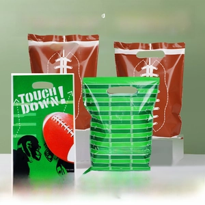 Detail of American football theme party favor bags with green field and red stitching designs