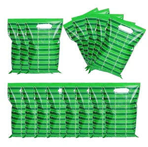 Detail of green striped plastic gift bags with oval die-cut handles for sports parties