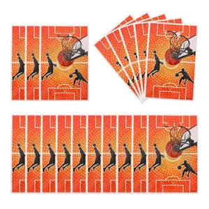 Macro shot of orange basketball themed party favor stickers featuring player silhouettes