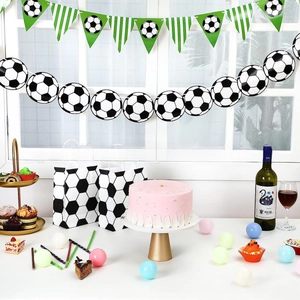 Close-up of football party set including banners and soccer print paper gift bags