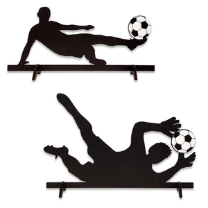 Macro detail of wooden soccer silhouettes showing a striker and goalkeeper on stands