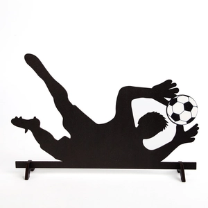 Wooden silhouette of a soccer goalkeeper jumping to save a ball for table decoration