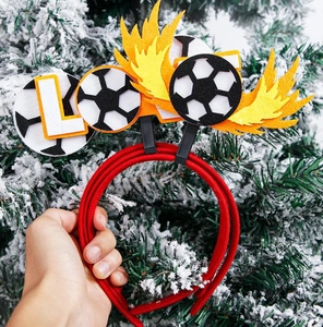 Close-up of a football party headband with felt soccer ball and flame ornaments