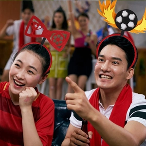 Detail of red bow and fire soccer headbands for football fans party decorations