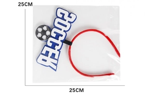 Detail of soccer themed headband with SOCCER lettering and ball in plastic packaging