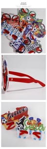 Detailed views of red football party glasses with felt soccer ball and trophy decorations