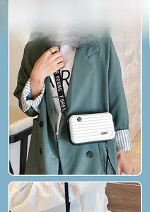 Mini hard shell suitcase bag in white with 'Forever Young' wide strap cross-body style