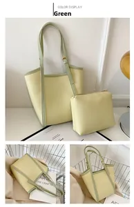 Detail of beige tote bag set with green trim and matching inner pouch on minimalist background
