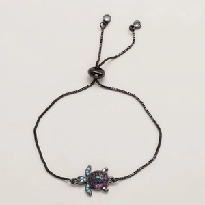 Detail of adjustable turtle bracelet with colorful micro-pave zircons and black chain