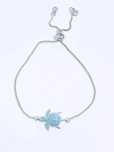 Detail of adjustable box chain with turtle charm featuring blue opal-like stone inlays
