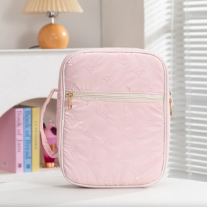 Pink quilted travel book bag with bow patterns and zipper for secure portable storage