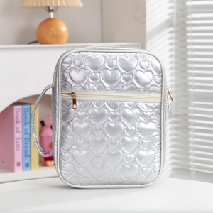 Silver heart-quilted portable book organizer bag with metallic finish and gold zipper