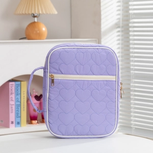 Purple quilted prayer book cover bag with heart pattern and golden zipper detail
