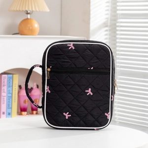 Black quilted book organizer with pink bow embroidery and golden zipper handles