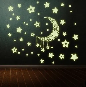 Luminous wall stickers set showing a glowing crescent moon and stars in the dark room