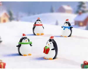 Set of four festive Christmas penguin figurines with colorful scarves on faux snow