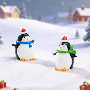 Christmas penguin figurines with holiday scarves and hats in a snowy winter landscape