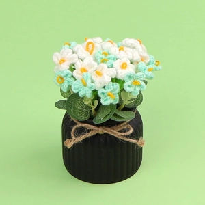 Handmade crochet flower potted plant with mint green blooms and rustic twine bow