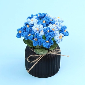 Handmade crochet blue flower potted plant with blue petals and black ceramic base