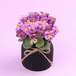 Handmade crochet potted flower with purple and pink blossoms and a brown bow knot