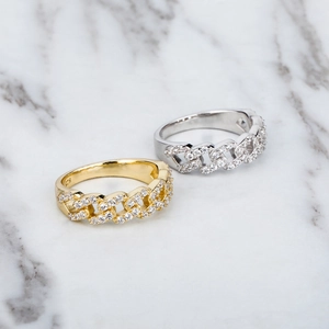 925 silver Cuban link rings with pave zircons in gold and silver on white marble