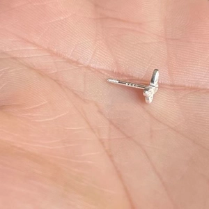 Detailed macro view showing S925 hallmark on butterfly screw back silver stud earring