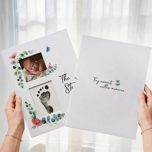 White floral baby milestone book set for newborn photos and handprints recording