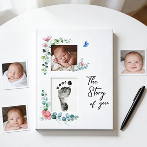 The Story of You baby memory book with floral design and photo foot print windows
